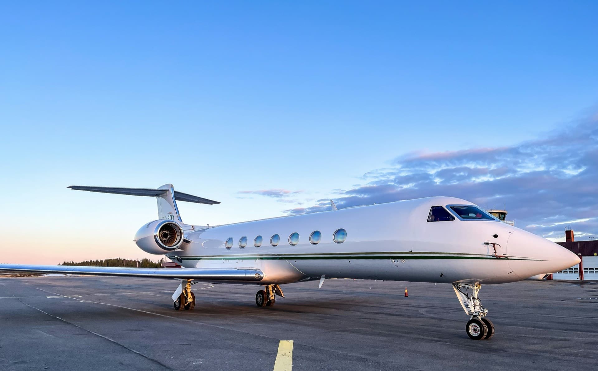 Private jet on the tarmac at dusk before a transfer to the yacht