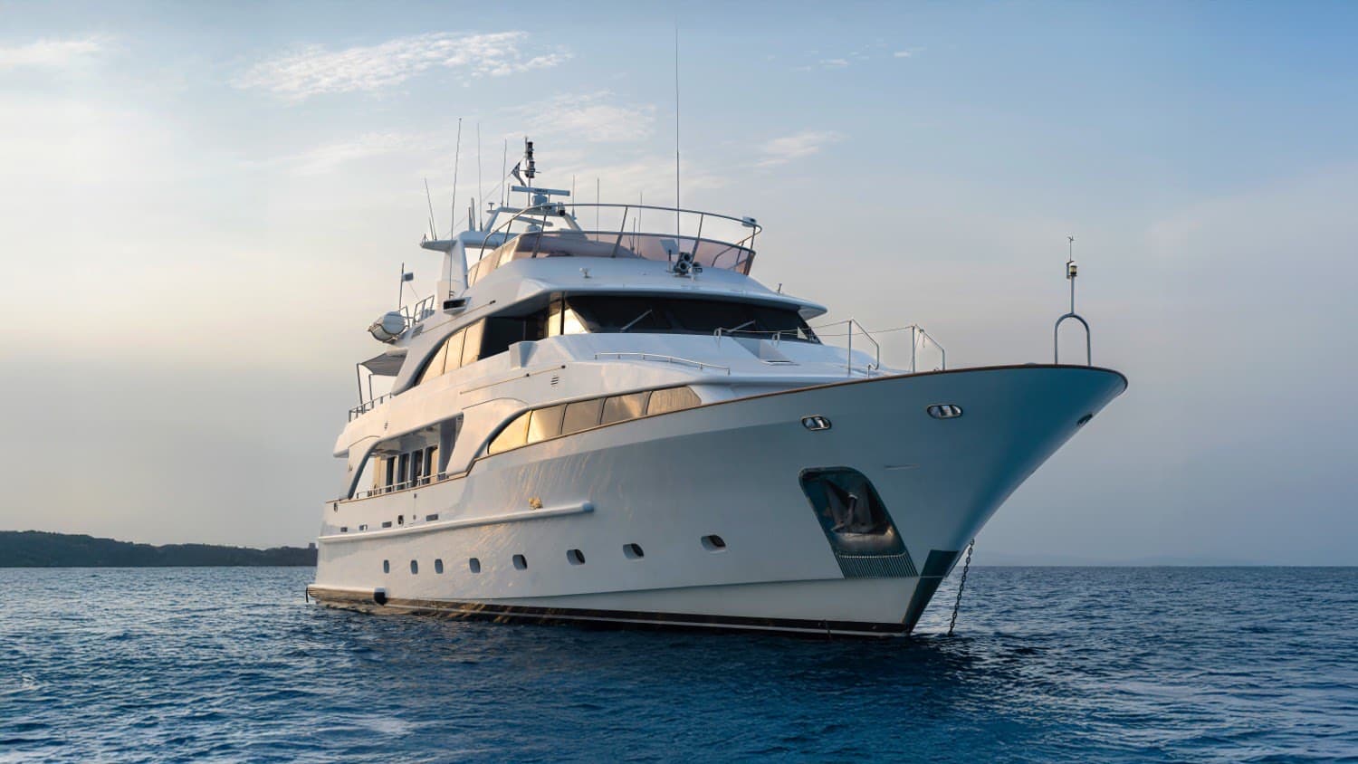 Luxury superyacht anchored off the Ibiza coast at golden hour